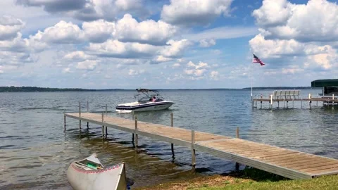 CROW WING CO, MN - 18 JUN 2021: Minnesota lake scene and boat leaving shore Stock Footage 157366114