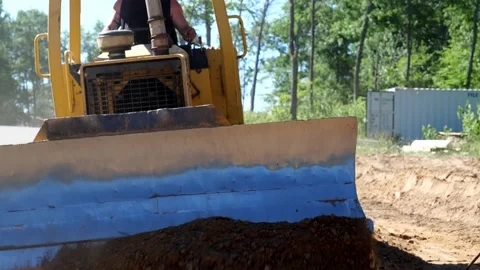 CROW WING CO, MN - 18 JUN 2021: Bulldozer pushes dirt toward camera. Stock Footage 157561129