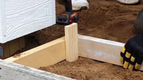 CROW WING CO, MN - 3 MAY 2021: Gloved hands and hammer and wood stake. Stock Footage 155134473
