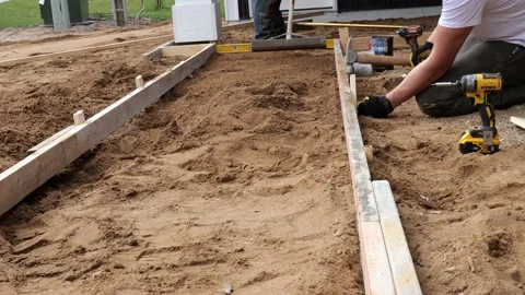 CROW WING CO, MN - 3 MAY 2021: Workers prepare to make a concrete sidewalk. Stock Footage 155134476