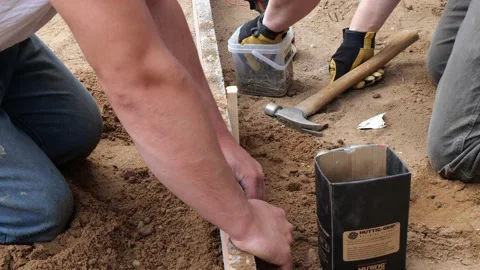 CROW WING CO, MN - 3 MAY 2021: Workers make a form for concrete sidewalk. Stock Footage 155134491