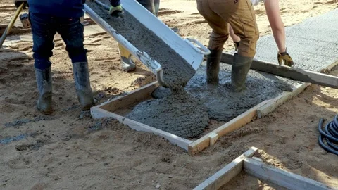 CROW WING CO, MN - 3 MAY 2021: Wet cement concrete pours out of a chute. Stock Footage 155134795