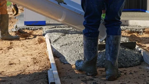 CROW WING CO, MN - 3 MAY 2021: Wet cement concrete pours out of chute. Stock Footage 155134993