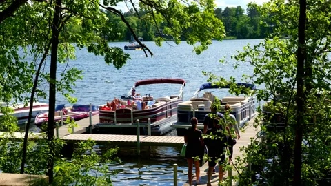 CROW WING CO, MN - 30 MAY 2021: Family walks to marina on a Minnesota lake. Stock Footage 155448709