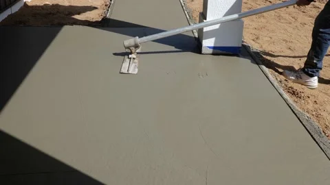 CROW WING CO, MN - 4 MAY 2021: Concrete float on new sidewalk cement. Stock Footage 155511329