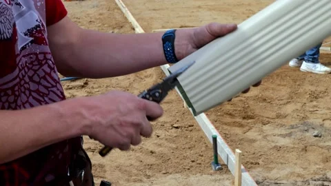 CROW WING CO, MN - 5 MAY 2021: Construction worker crimps aluminum. Stock Footage 156051287