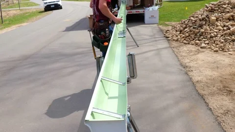 CROW WING, CO, MN - 5 MAY 2021: Rain gutter braces are placed by a worker. Stock Footage 156670754