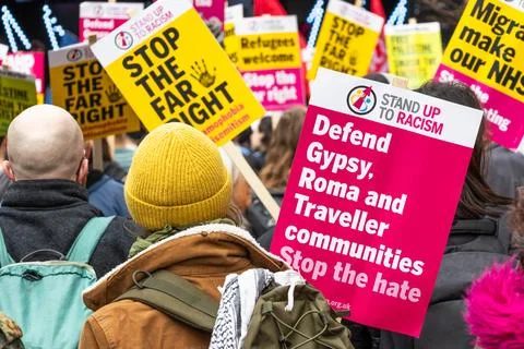 Crowd of activists holding placards opposing discrimination and supporting hu Stock Photos
