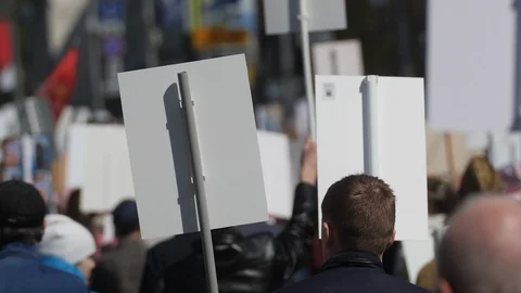 Crowd activists at a rally with posters are on the road walking banner Europe. Stock Footage