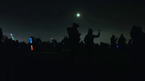 Crowd and moon in the dark before fireworks start. 動画素材 82286121