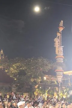 Crowd and Penjor Pole Under Full Moon at Karya Agung Panyegjeg Bhumi Ubud Bali Stock Photos