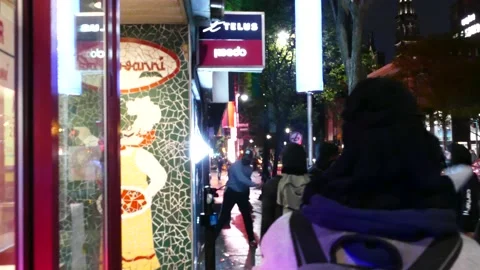 Crowd of angry protesters shatter a window storefront with blunts objects Stock Footage 137553085