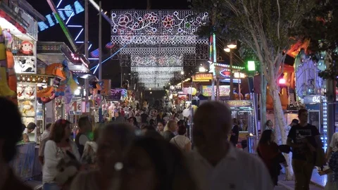 Crowd of anonymous people walking on busy city street during the Feria festival Stock Footage 82913963