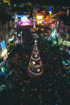 Crowd around illuminated Christmas tree in Ramallah Stock Photos