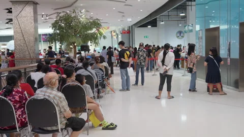 Crowd Of Asian People Sit &amp; Wait For Indoor Covid Flu Indoor Vaccination Clinic Stock Footage 256097141