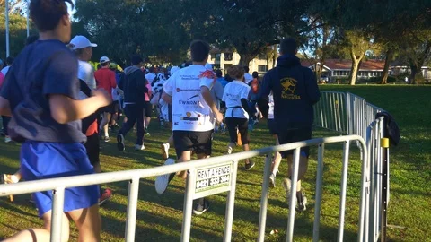 A crowd of athletes running in a marathon Stock Footage 94170764