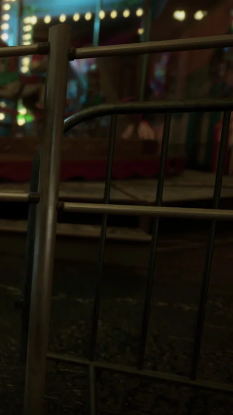 Crowd barrier set up at carnival event with lights in the background Stock Footage 339783606