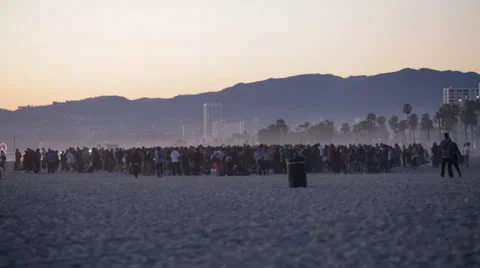 Crowd at the beach during sunset Stock Footage 37025380