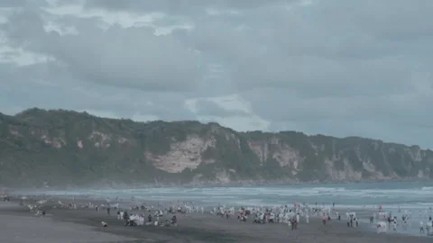 Crowd of Beachgoers Enjoying Cloudy Day at Beautiful Coastline with Crashin.. Stock Footage 303340472
