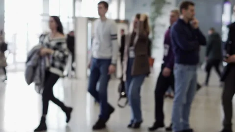 A crowd of blurry people in a large, bright business center lobby. Stock Footage 197409580