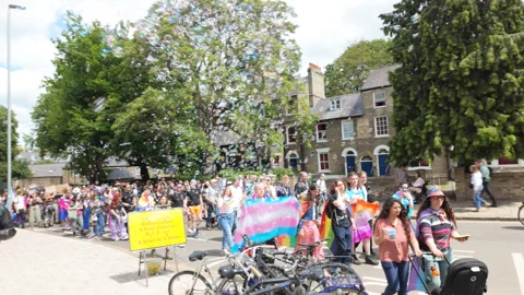 From the crowd at Cambridge Pride, watching marchers and blowing bubbles Stock Footage 338016938