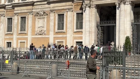Crowd of Catholic pilgrims waiting in long queue to enter Papal Basilica Stock Footage 308092679