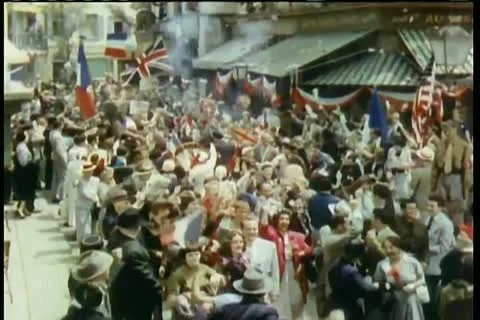 Crowd celebrating liberation in the streets at the end of World War II Stock Footage
