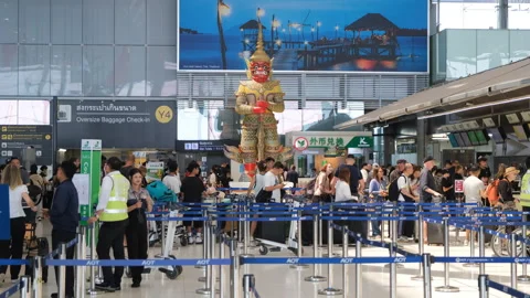Crowd checking in for flights in Airport Stock Footage 333102204