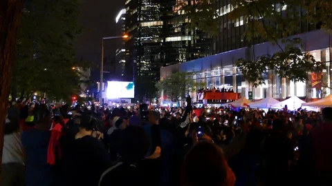 Crowd cheering in front of huge screen downtown Stock Footage 114859278