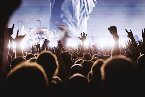 Crowd Cheering with Raised Hands at Blue Lit Music Concert Performance Stock Photos