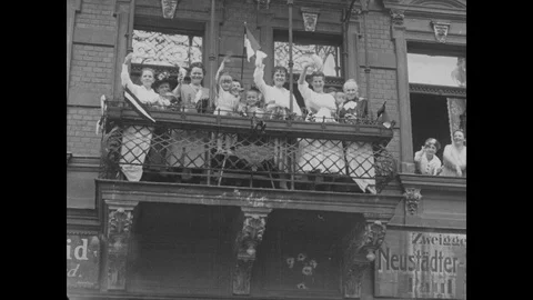 Crowd cheering the rally from window and officers offer wreath on a grave Stock Footage 109516351