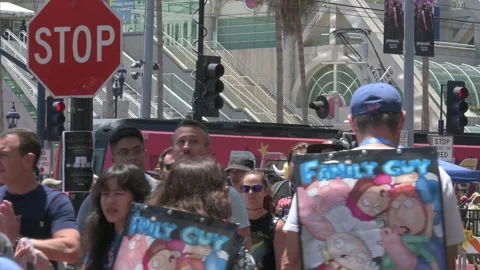 Crowd close up, trolley rolls by, convention center Stockbeeldmateriaal 246635418