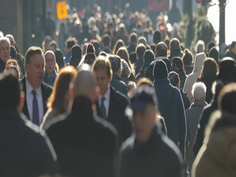 Crowd of commuter people walking street sidewalk slow motion Stock Footage