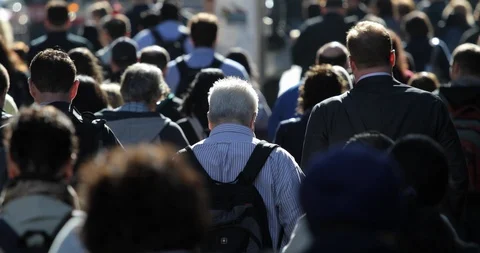 Crowd of commuter people walking street to work backlit silhouette slow Stock Footage