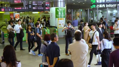 Crowd of Commuters Passing Ticket Gates at Tokyo Shinjuku Train Station - The Stock Footage 97502367