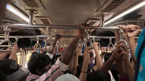 Crowd of commuters traveling inside an overcrowded train holding onto handles Stock Footage 339339839