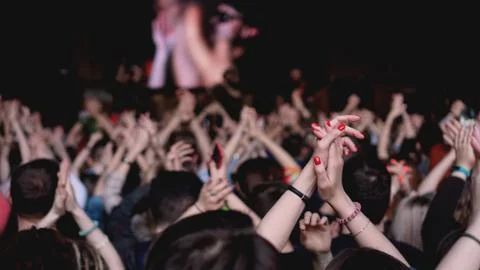 Crowd at concert - Cheering crowd in bright colorful stage lights Stock Photos