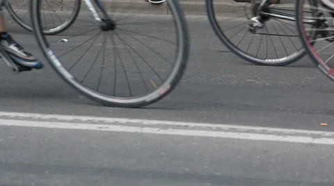 A crowd of cyclists riding on the pavement left to right 스톡 동영상 63503141