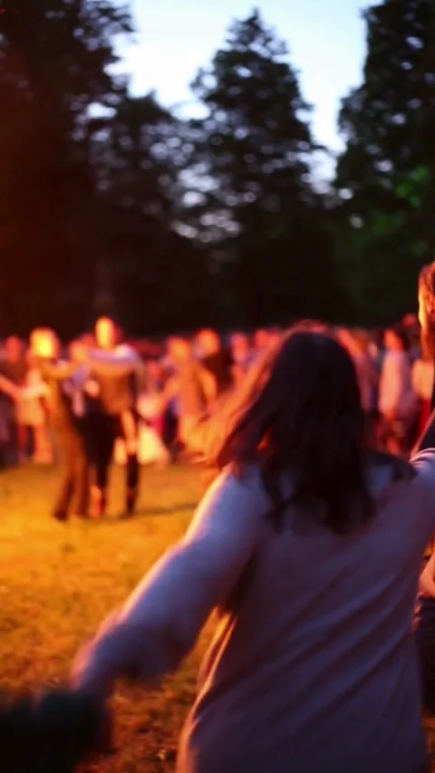 Crowd dancing around bonfire  Stock Footage 322070492
