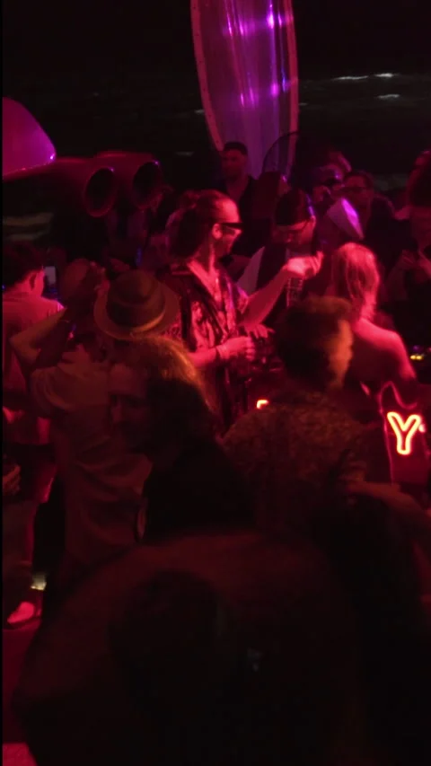 Crowd Dancing Around DJ Booth at Beach Club Night Party 스톡 동영상 337902828