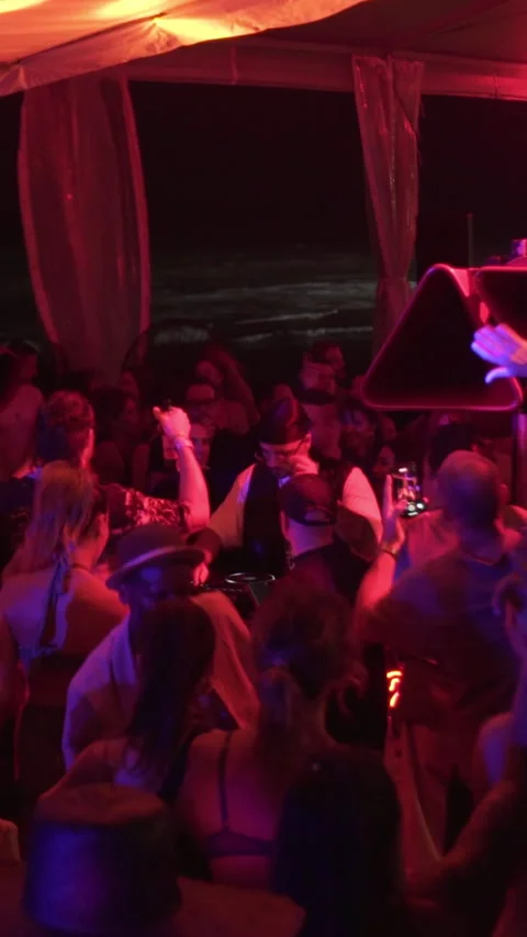 Crowd Dancing at Beach Club Night Party with Ocean View Stock Footage 337902832