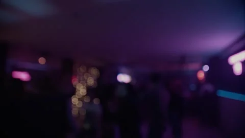 Crowd dancing under colorful spotlights and lasers, captured in defocused. Stock Footage 253594872