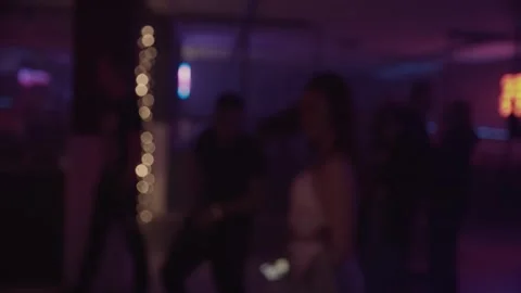 Crowd dancing under colorful spotlights and lasers, captured in defocused. Stock Footage 253594993