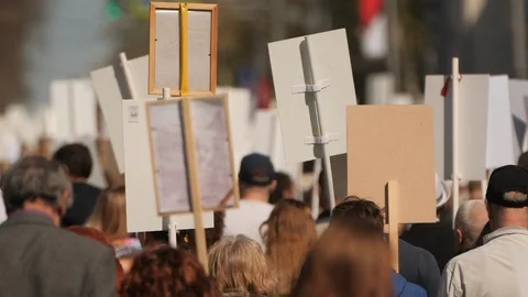 A crowd of demonstrators walking agitating on strike against the government. Stock Footage 121279402