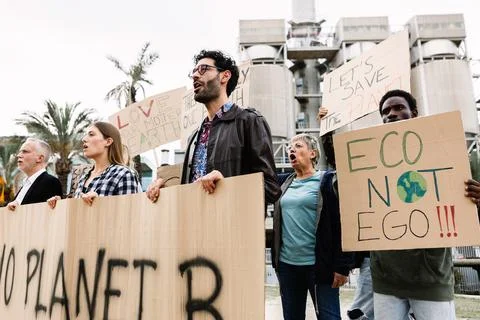 Crowd of diverse protestors demonstrating against climate change Stock Photos