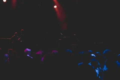 Crowd at empty music stage waiting for rock band. Stock Photos
