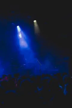 Crowd at empty music stage waiting for rock band. Stock Photos
