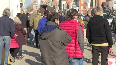 Crowd of eople line up at pharmacy for COVID 19 vaccine shot in Toronto Vídeos de archivo 150340611