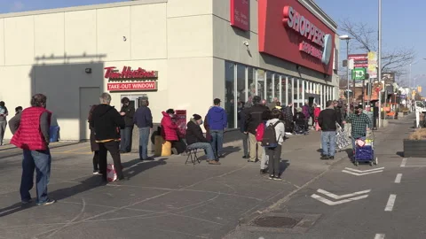 Crowd of eople line up at pharmacy for COVID 19 vaccine shot in Toronto Video stock 150341651