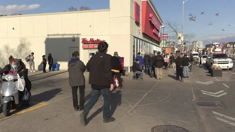 Crowd of eople line up at pharmacy for COVID 19 vaccine shot in Toronto Stock-Footage 150342406